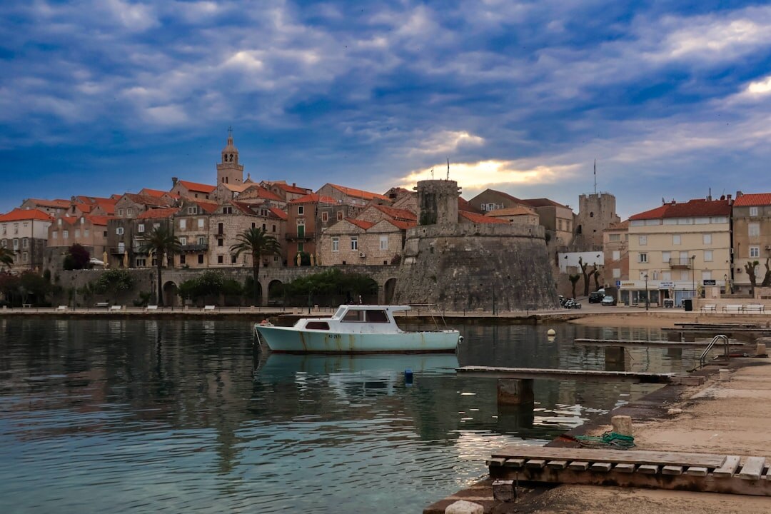 Traditional wooden fishing boats moored in a small Croatian harbor at sunrise