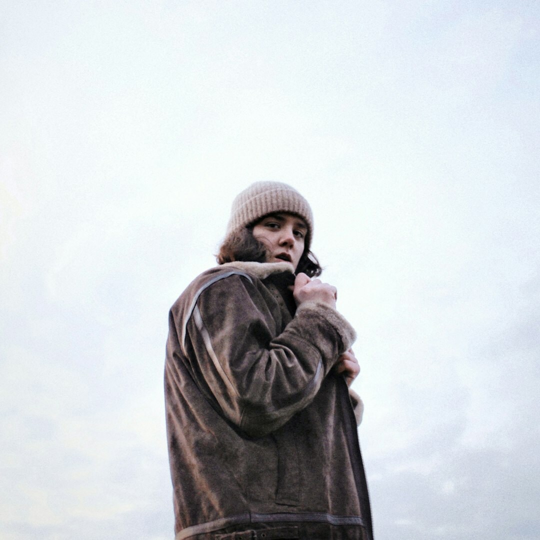 Croatian documentary photographer with beard holding a camera, outdoor portrait