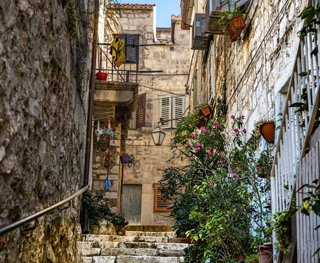 Narrow stone alley in an old Dalmatian coastal town at golden hour
